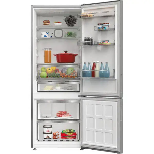 Frigorifero Hotpoint a due porte con congelatore inferiore carico di cibo e bevande